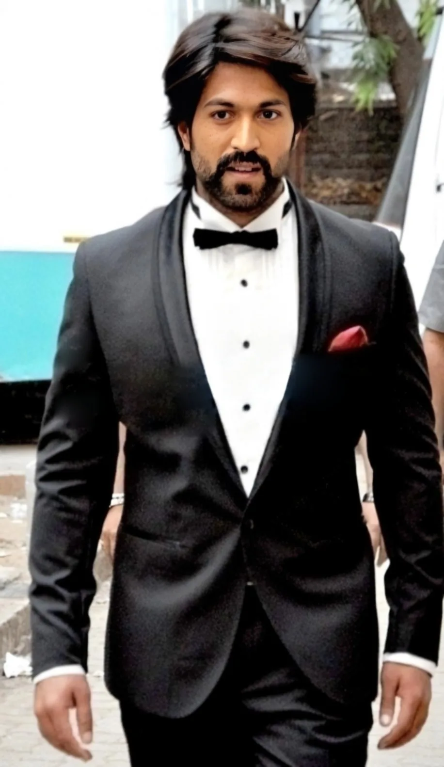 Actor Yash wearing a black tuxedo at an event.